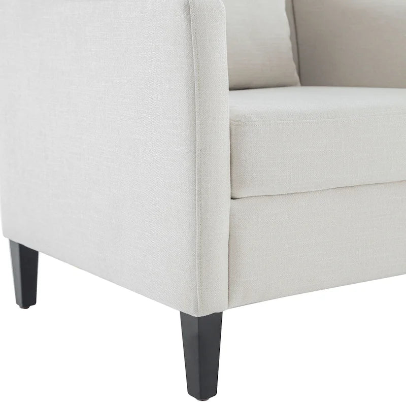 Sillón decorativo tapizado en beige con botones y cojín lumbar