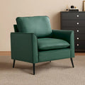 Sillón decorativo tapizado en verde con cojines y almohadas